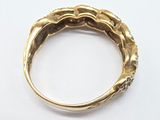 a close up of a gold ring on a white surface