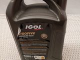a close up of a bottle of motor oil on a table