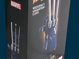 a box with a lego figure of a man holding two knives