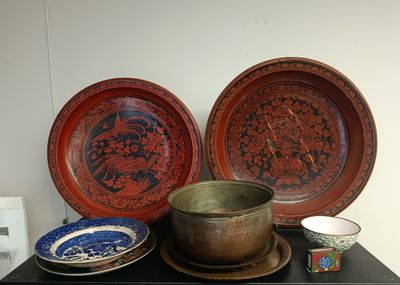 three bowls and two plates on a black table
