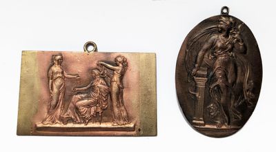 two antique bronze medallions of a woman and a man