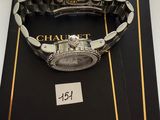 a watch sitting on a book with a price tag on it