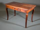 a small wooden table with two drawers on it