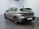 the rear view of a silver car in a showroom