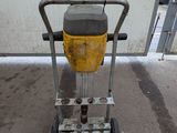 a yellow and black trash can sitting on a metal cart