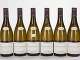 six bottles of wine are lined up in a row on a white surface