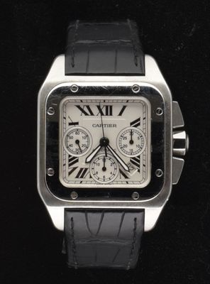 a close up of a watch on a black surface