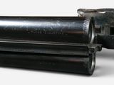 a close up of a gun on a white surface