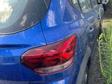 a blue car parked in front of a building