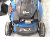 a blue lawn mower that is sitting on the ground