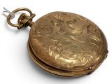 a gold pocket watch with a chain on a white surface