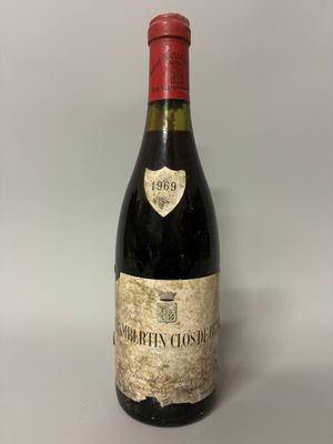 une bouteille de vin posée sur une table blanche
