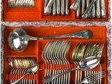many different types of silverware in a wooden box