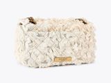 the small white purse is adorned with white flowers and a gold chain