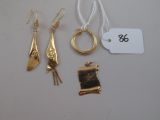 a lot of gold jewelry on a white table