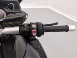 a close up of a motorcycle handlebar with a clock on it