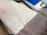 a box full of pillows and a pillow case with a picture of an elephant on it