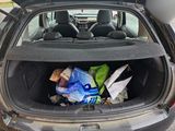 a trunk of a car with a bunch of items in it