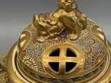an image of a gold plate with a dog on top of it