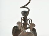 a metal candle holder with a spiral design on it