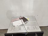 an image of a microwave sitting on top of a wooden pallet