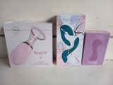 three boxes of different types of sex products sitting on a table