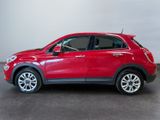 the red fiat suv is parked in a large room