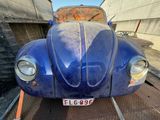 a blue car that is parked on the side of the road