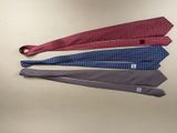 three ties are laid out on a table with one tied to the other