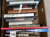 a cardboard box full of books on the floor