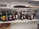 many bottles of alcohol on the shelves in the kitchen