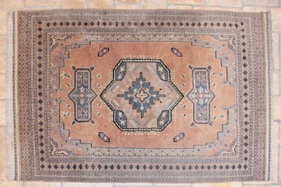 a rug hanging on a brick wall in a room