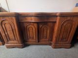 a close up of a wooden desk with two doors on top of it