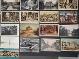 many pictures of old buildings on display on the wall