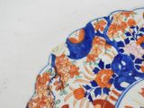 a plate with a design of flowers and birds on it