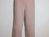 pink pants on a mannequin stand against a white wall