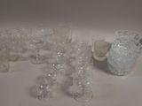 a lot of glasses and vases sitting on a table