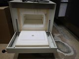 a small open box with a lid on top of it