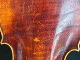 a close up of a violin on a black background
