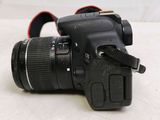 a camera that is sitting on a table with a strap around it