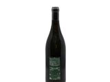 the bottle of wine is empty on a white surface