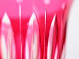 a close up of a pink glass with a lot of toothbrushes in it