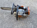 a close up of a chainsaw on the ground on the ground