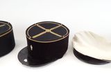 three hats are lined up on top of each other on a white surface