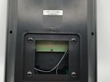 a close up of a black electronic device on a white surface