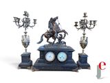 a statue of a man riding a horse on a clock