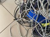 a pile of wires on the floor next to a toilet