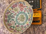 a bowl sitting on top of a table next to a calculator