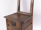 une petite commode en bois surmontée d'un miroir