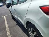 a white car parked in a parking lot next to a building